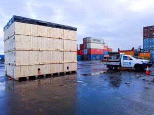 crate n pack solutions ute and wooden shipping crate with shipping containers in background