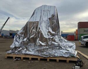 heavy machine in vci barrier bag and strapped to timber base