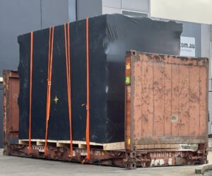 shipping container and black shrink wrapped machine