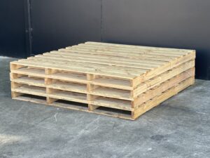 wooden custom pallet with image of crate n pack solutions logo in background