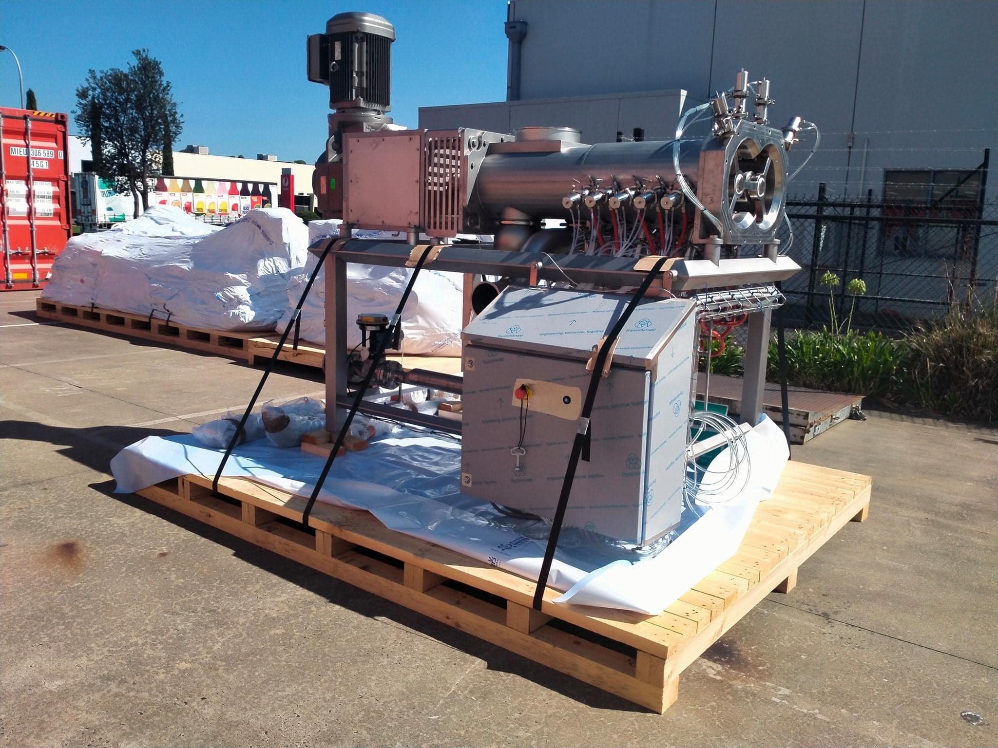 machine on top of timber base with image of crate n pack solutions logo in background