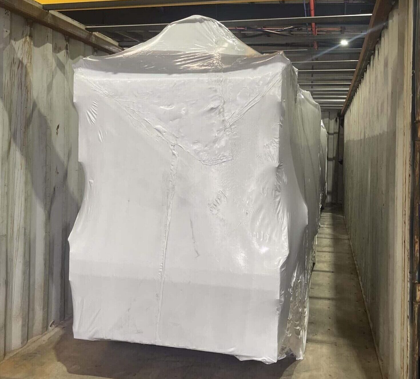 image of shrink wrapped machine inside shipping container in Melbourne