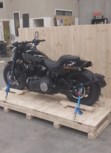 motorbike in crate with Crate n Pack Solutions logo in background.