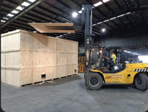 shipping crate and forklift in crate n pack warehouse