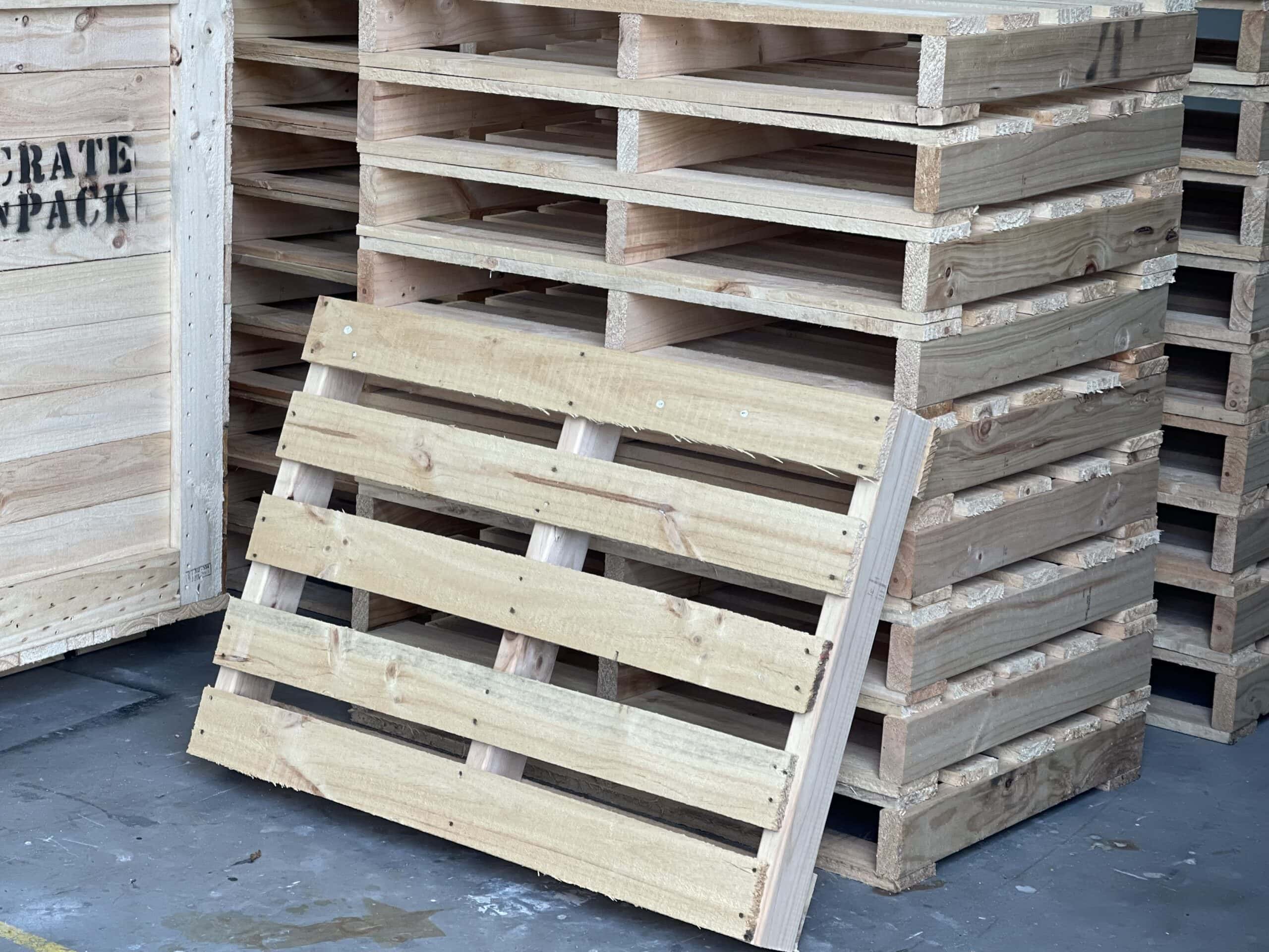 wooden custom pallet with image of crate n pack solutions logo in background