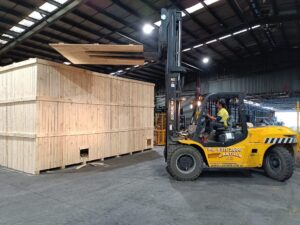 Wooden shipping crate and forklift in Melbourne factory