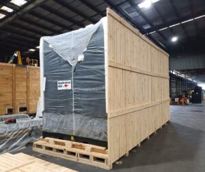 wooden shipping crate with cumins machine inside