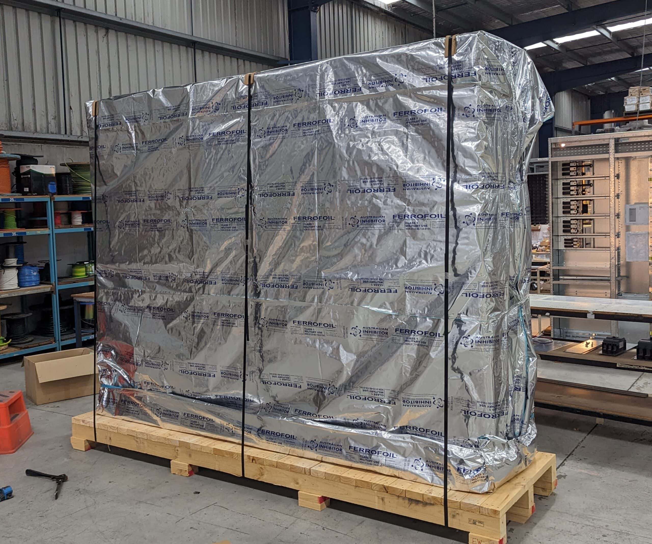 machine wrapped in VCI barrier foil and a machinery base pallet