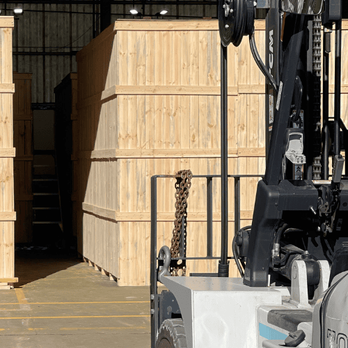 large wooden shipping crates and forklift