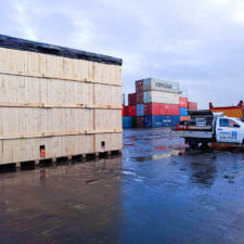 crate n pack solutions ute and wooden shipping crate with shipping containers in background