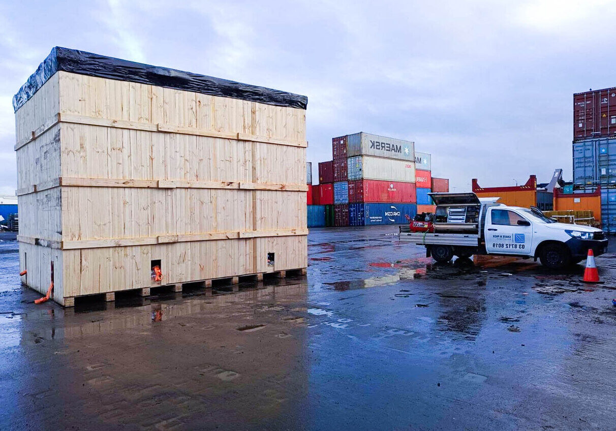 crate n pack solutions ute and wooden shipping crate with shipping containers in background