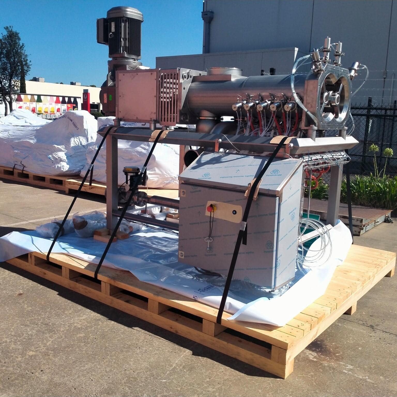 machine on top of timber base with image of crate n pack solutions logo in background