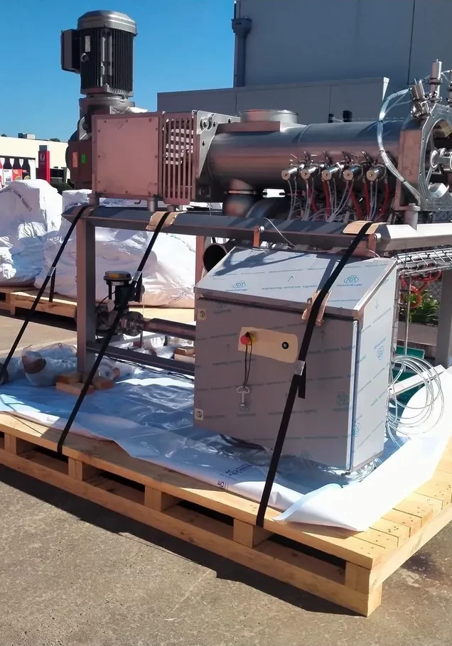 image of machine being shrink wrapped while on a timber base