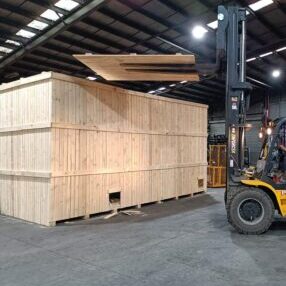 wooden shipping crate and forklift