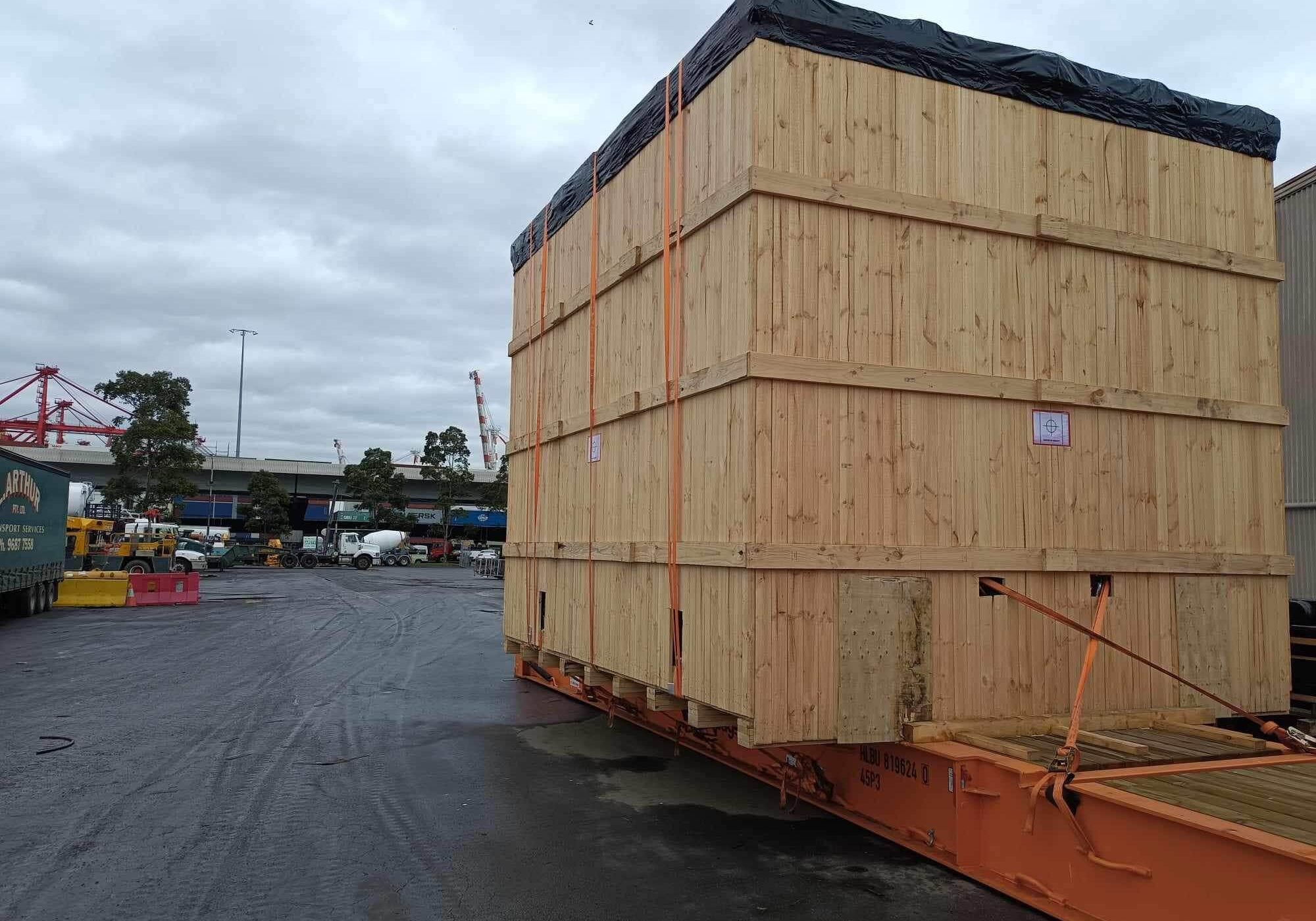 timber shipping case on top of flat racked shipping container