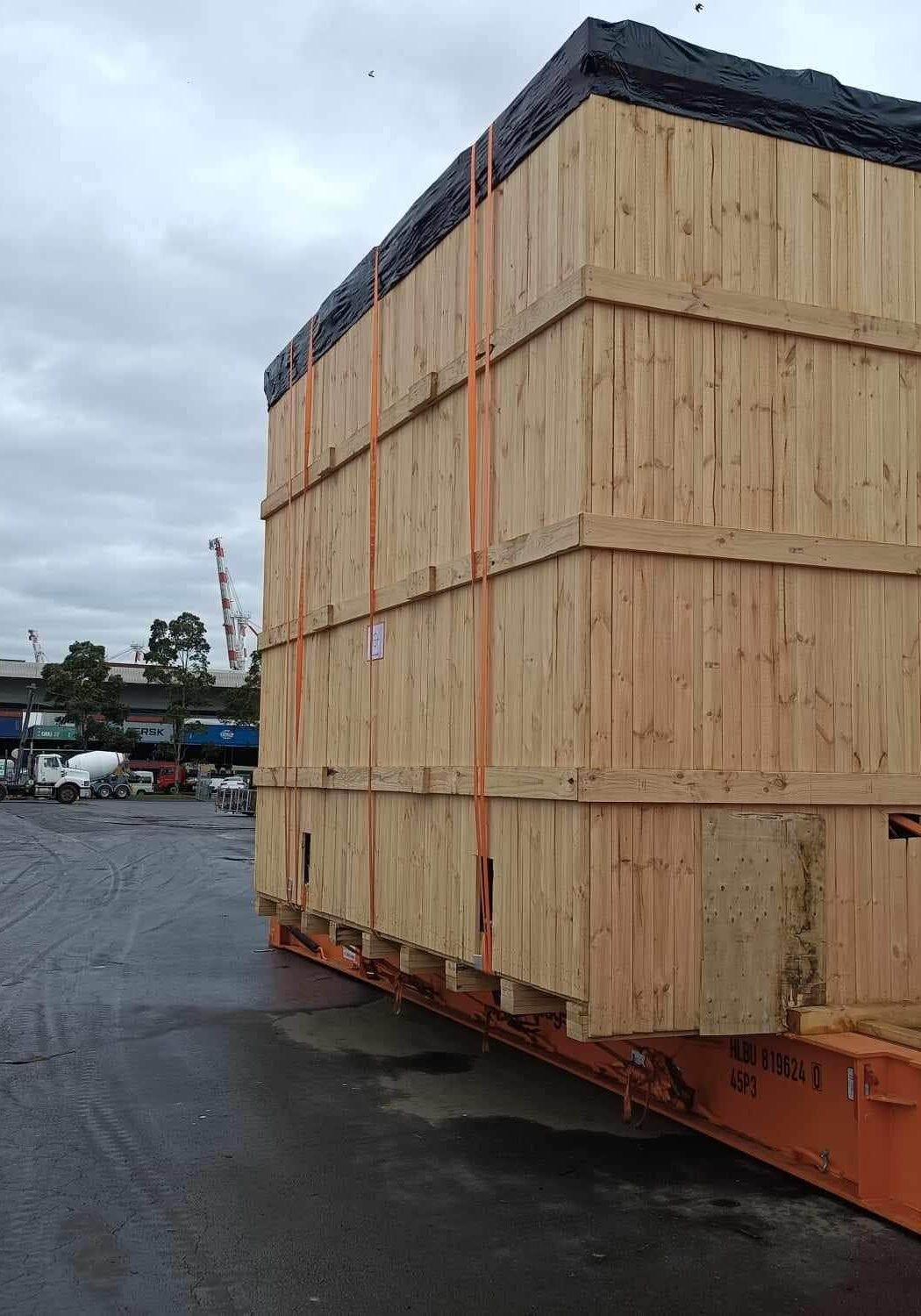 timber shipping case on top of flat racked shipping container