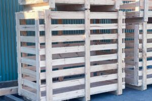 timber shipping crate with image of crate n pack solutions logo in background