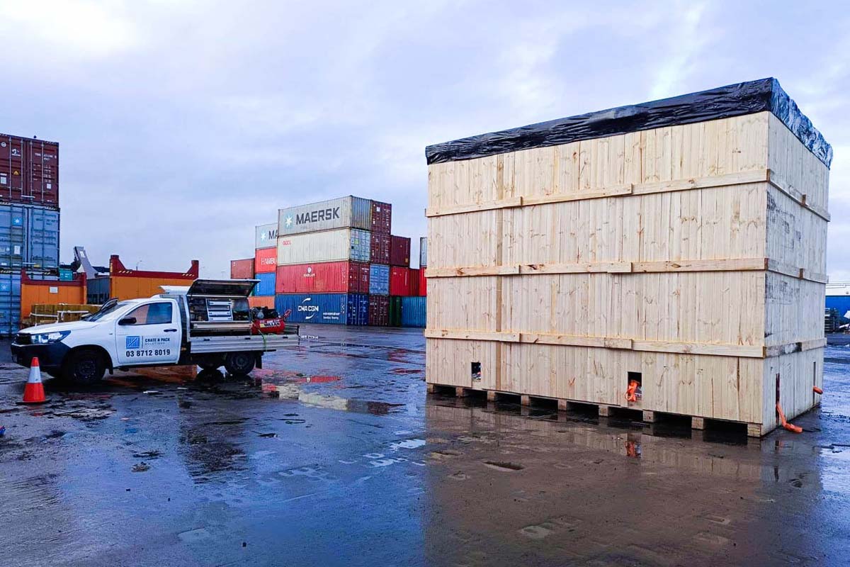 wooden shipping crate with shipping containers in background