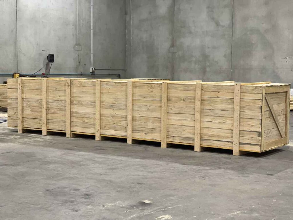 large wooden shipping crate with image of Crate n Pack Solutions in background