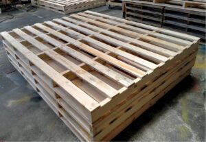 wooden custom pallet with image of crate n pack solutions logo in background